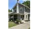 Side view of the home with a screened porch, showcasing the architectural details and landscaping at 5829 Broadway St, Indianapolis, IN 46220