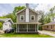 Charming two-story home featuring a screened-in front porch and classic architectural details at 5829 Broadway St, Indianapolis, IN 46220