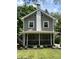 Charming home featuring a screened front porch, light-colored siding and white trim at 5829 Broadway St, Indianapolis, IN 46220