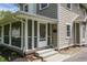 Close up of front porch entrance with tiled steps and a white framed screen door at 5829 Broadway St, Indianapolis, IN 46220