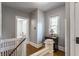 Hallway area showcasing wood floors, natural light, and traditional banister at 5829 Broadway St, Indianapolis, IN 46220