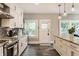 Updated kitchen boasting white cabinets, stainless appliances, granite countertops, and an exterior entrance door at 5829 Broadway St, Indianapolis, IN 46220