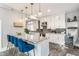 A spacious kitchen featuring white cabinets, stainless steel appliances, and granite countertops with bar seating at 5829 Broadway St, Indianapolis, IN 46220