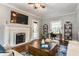 Cozy living room with a fireplace, a TV, a decorative rug, and hardwood floors at 5829 Broadway St, Indianapolis, IN 46220
