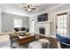 Inviting living room with a fireplace, television, and a patterned rug at 5829 Broadway St, Indianapolis, IN 46220