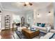 Bright living room with a sofa, modern decor, shiplap accent wall, and hardwood floors at 5829 Broadway St, Indianapolis, IN 46220