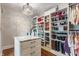 Large walk-in closet with custom shelving, ample storage, and a chandelier at 5829 Broadway St, Indianapolis, IN 46220