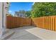 Backyard showcasing wooden fence, concrete patio, and surrounding trees at 608 East 21St St, Indianapolis, IN 46202