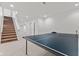Spacious finished basement with a ping pong table and stairs leading to the upper level at 608 East 21St St, Indianapolis, IN 46202