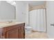 Bathroom features a vanity with dark wood cabinets and a shower with curtain at 608 East 21St St, Indianapolis, IN 46202