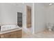 Bathroom with a jetted tub, separate shower with tile surround, and walk-in closet at 608 East 21St St, Indianapolis, IN 46202