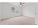Bedroom boasts a window with natural light, neutral carpet, and a ceiling fan at 608 East 21St St, Indianapolis, IN 46202