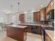 Spacious kitchen features dark wood cabinets, stainless appliances, a center island and an eat in area at 608 East 21St St, Indianapolis, IN 46202
