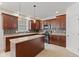Well-equipped kitchen with dark wood cabinets, an island, and tile backsplash at 608 East 21St St, Indianapolis, IN 46202