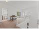 Upstairs landing featuring neutral carpet, natural light, and an adjacent bathroom at 608 East 21St St, Indianapolis, IN 46202