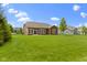 Expansive backyard with lush green lawn and a cozy home, great for Gathering gatherings and outdoor activities at 6150 Rolling Rock Ln, Noblesville, IN 46062
