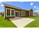 Exterior view of home with patio, dark siding, and green grass at 6150 Rolling Rock Ln, Noblesville, IN 46062