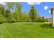Large backyard with green grass and tree line at 6150 Rolling Rock Ln, Noblesville, IN 46062