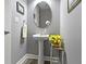 Powder room showcasing a stylish pedestal sink and decorative accent table at 6150 Rolling Rock Ln, Noblesville, IN 46062