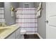 Bathroom with a white vanity and red striped shower curtain creating a clean aesthetic at 6150 Rolling Rock Ln, Noblesville, IN 46062