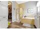 Updated bathroom features a soaking tub, tiled shower, and wood-look floors at 6150 Rolling Rock Ln, Noblesville, IN 46062