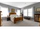 Comfortable bedroom with natural light, stylish curtains, and a decorative quilt at 6150 Rolling Rock Ln, Noblesville, IN 46062