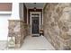 Inviting front porch with stone accents, a decorative wreath, and a welcoming ambiance at 6150 Rolling Rock Ln, Noblesville, IN 46062