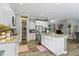 Spacious kitchen featuring white cabinetry, granite counters, stainless steel appliances, and hardwood floors at 6150 Rolling Rock Ln, Noblesville, IN 46062