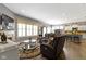 Spacious living area featuring a fireplace, a mounted television, and an open view of the kitchen at 6150 Rolling Rock Ln, Noblesville, IN 46062