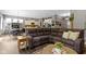 Inviting living room with a large sectional sofa and open concept to kitchen and dining area at 6150 Rolling Rock Ln, Noblesville, IN 46062