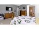 Spacious main bedroom with en-suite bath, wood furnishings, and TV at 6150 Rolling Rock Ln, Noblesville, IN 46062