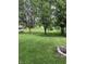 Expansive backyard with lush green grass and mature trees, offering a serene outdoor space at 6430 E Stop 11 Rd, Indianapolis, IN 46237