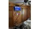 Bedroom featuring knotty pine walls, ceiling fan, TV, and walker accessible mobility assistance at 6430 E Stop 11 Rd, Indianapolis, IN 46237