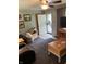 Comfortable living room with a front door, plush furniture, neutral carpet, and wood accents at 6430 E Stop 11 Rd, Indianapolis, IN 46237