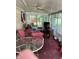 Enclosed sunroom featuring a ceiling fan, plenty of natural light and access to the backyard at 6430 E Stop 11 Rd, Indianapolis, IN 46237