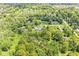 An aerial view of a property showcasing its large manicured lawns and lush tree coverage surrounding the residence at 6464 Whitley Ln, Indianapolis, IN 46260