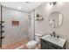 Modern bathroom features a walk-in shower with hexagon tile and sleek vanity with oval mirror at 6464 Whitley Ln, Indianapolis, IN 46260