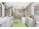 Bright bathroom with stylish fixtures, shower and tub and decorative green accents at 6464 Whitley Ln, Indianapolis, IN 46260