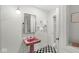 Stylish bathroom featuring a black and white checkered floor, a unique pedestal sink, and a sleek mirror at 6464 Whitley Ln, Indianapolis, IN 46260