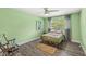 Comfortable bedroom with a large window, ceiling fan, and neutral tones, perfect for relaxation at 6464 Whitley Ln, Indianapolis, IN 46260