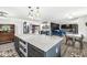 Modern kitchen featuring a large island, dining area, and open layout to the living room at 6464 Whitley Ln, Indianapolis, IN 46260
