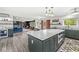 Bright open kitchen with island, stainless steel appliances, and hardwood floors at 6464 Whitley Ln, Indianapolis, IN 46260