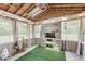 Cozy sunroom with stone fireplace, skylight, and decorative lighting at 6464 Whitley Ln, Indianapolis, IN 46260