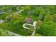 Aerial view of a property with a long driveway, mature trees, and a large manicured lawn at 6465 Lawrence Dr, Indianapolis, IN 46226