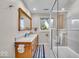 Bathroom featuring a double vanity, granite countertop, and walk-in shower, offering both style and functionality at 6465 Lawrence Dr, Indianapolis, IN 46226