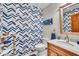 Bathroom with vanity, designer wallpaper, and updated fixtures at 6465 Lawrence Dr, Indianapolis, IN 46226