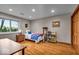 Comfortable bedroom with a window, wood floors, a cozy bed, and ample space for relaxation and storage at 6465 Lawrence Dr, Indianapolis, IN 46226