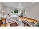 Sunlit bedroom with hardwood floors, large windows, closet, and a dedicated desk area for work or study at 6465 Lawrence Dr, Indianapolis, IN 46226