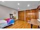 A cozy bedroom featuring hardwood floors, natural light, and a large closet for storage at 6465 Lawrence Dr, Indianapolis, IN 46226