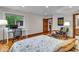 Bright bedroom featuring hardwood floors, a work space, and a comfortable sitting area at 6465 Lawrence Dr, Indianapolis, IN 46226